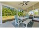 Screened porch with table and chairs, offering a comfortable view of lush backyard at 1411 Homecoming Blvd, Ravenel, SC 29470