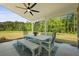 Covered patio with dining table, bench, and chairs, great for enjoying the outdoors at 1411 Homecoming Blvd, Ravenel, SC 29470