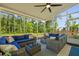 Spacious covered patio with outdoor sofas and a scenic view of surrounding greenery at 1411 Homecoming Blvd, Ravenel, SC 29470