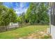 Expansive backyard with lush lawn and picket fence overlooking a serene lake at 1485 Endicot Way, Mount Pleasant, SC 29466