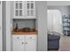 Built-in white bar area with wine storage, perfect for entertaining, next to the home's entryway at 1485 Endicot Way, Mount Pleasant, SC 29466