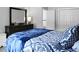 Well-lit bedroom with blue accents, a dresser with mirror, and closet doors at 1485 Endicot Way, Mount Pleasant, SC 29466