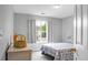 A bright bedroom features light gray walls and a window with curtains at 1485 Endicot Way, Mount Pleasant, SC 29466