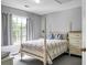 Bedroom featuring a four-poster bed with decorative pillows and a view through the window at 1485 Endicot Way, Mount Pleasant, SC 29466