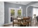 Cozy dining area featuring a round table with seating and a view of the backyard through French doors at 1485 Endicot Way, Mount Pleasant, SC 29466