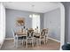 Bright dining room with an elegant chandelier, large windows, and seating for six at 1485 Endicot Way, Mount Pleasant, SC 29466