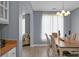 Dining room featuring a dining table with six chairs, a modern chandelier, and a large window at 1485 Endicot Way, Mount Pleasant, SC 29466