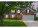 Charming two-story brick home with a well-manicured lawn, a two-car garage, and mature trees at 1485 Endicot Way, Mount Pleasant, SC 29466