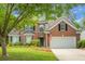 Two-story brick home featuring a well-kept lawn, white two-car garage, and ample windows at 1485 Endicot Way, Mount Pleasant, SC 29466
