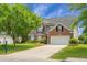 Traditional two-story brick home with a well-manicured front yard and two-car garage at 1485 Endicot Way, Mount Pleasant, SC 29466