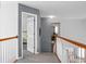 Upstairs hallway with wood railing, white spindles, and neutral carpet at 1485 Endicot Way, Mount Pleasant, SC 29466
