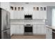 Modern kitchen featuring stainless steel appliances, white cabinets and tile backsplash at 1485 Endicot Way, Mount Pleasant, SC 29466