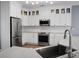 Bright kitchen showcasing white cabinetry, stainless steel appliances, and modern fixtures at 1485 Endicot Way, Mount Pleasant, SC 29466