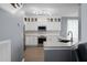 Well-lit kitchen featuring white cabinets, stainless steel appliances, and a functional breakfast bar at 1485 Endicot Way, Mount Pleasant, SC 29466