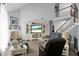 Bright living room with vaulted ceilings, open staircase, and a cozy fireplace with built-in shelving at 1485 Endicot Way, Mount Pleasant, SC 29466