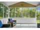 Inviting screened porch with wicker seating and a view of the peaceful, wooded surroundings at 1485 Endicot Way, Mount Pleasant, SC 29466