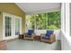Screened porch with comfortable wicker furniture, ceiling, and view of backyard at 1485 Endicot Way, Mount Pleasant, SC 29466