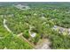 A beautiful aerial view showcases the wooded lot surrounding this house at 1502 Southwick Dr, Johns Island, SC 29455