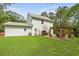Wide backyard featuring a patio with a pergola, green lawn, and mature trees at 1502 Southwick Dr, Johns Island, SC 29455
