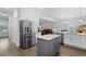 Open-concept kitchen with white cabinets, stainless steel appliances, and a gray island with a hardwood floor at 1502 Southwick Dr, Johns Island, SC 29455