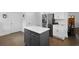 Bright kitchen featuring gray island, stainless refrigerator, white cabinets, and hardwood floors at 1502 Southwick Dr, Johns Island, SC 29455