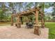 Outdoor patio featuring a pergola, stone pillars, and a dining table at 1502 Southwick Dr, Johns Island, SC 29455