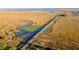 Scenic aerial view showcases a beautiful marsh landscape with a wooden walkway, and bodies of water at 1505 Fort Palmetto Cir, Mount Pleasant, SC 29466