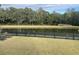 View of the backyard with a pond, well-maintained grass, and fencing around the yard at 1505 Fort Palmetto Cir, Mount Pleasant, SC 29466
