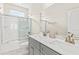 This bathroom features double sinks, gray cabinets, a white marble countertop, and a shower-tub combo at 1505 Fort Palmetto Cir, Mount Pleasant, SC 29466