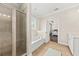 This bathroom features a glass shower, a tub, a light-colored tile floor, and a view of the Primary bedroom at 1505 Fort Palmetto Cir, Mount Pleasant, SC 29466