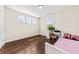 A cozy bedroom that features hardwood floors, natural light, and an adjacent desk for working at 1505 Fort Palmetto Cir, Mount Pleasant, SC 29466