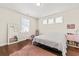 Cozy bedroom featuring hardwood floors, a large window, and a soft pink rug, perfect for relaxing at 1505 Fort Palmetto Cir, Mount Pleasant, SC 29466