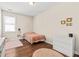 A minimalist bedroom with hardwood floors, a pink rug, and a view to an outside window at 1505 Fort Palmetto Cir, Mount Pleasant, SC 29466