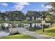 Community dock on a tranquil pond, surrounded by mature trees and lush landscaping at 1505 Fort Palmetto Cir, Mount Pleasant, SC 29466
