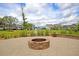 Cozy brick fire pit and patio area, overlooking a serene pond and neighborhood homes at 1505 Fort Palmetto Cir, Mount Pleasant, SC 29466