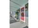 Inviting front porch featuring a red door, stylish decor, and comfortable seating at 1505 Fort Palmetto Cir, Mount Pleasant, SC 29466