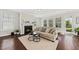 Bright living room featuring a fireplace, hardwood floors, and a cozy seating area at 1505 Fort Palmetto Cir, Mount Pleasant, SC 29466