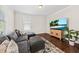 Cozy living room with a sectional sofa, stylish rug, and bright window at 1505 Fort Palmetto Cir, Mount Pleasant, SC 29466