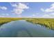Scenic marsh landscape featuring a waterway surrounded by tall grass, under a blue sky with white clouds at 1505 Fort Palmetto Cir, Mount Pleasant, SC 29466
