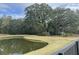 Scenic view of the pond bordered by well-maintained lawn and lush trees in a serene environment at 1505 Fort Palmetto Cir, Mount Pleasant, SC 29466
