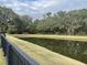 Scenic view of the pond bordered by well-maintained lawn and lush trees in a serene environment at 1505 Fort Palmetto Cir, Mount Pleasant, SC 29466