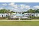 Community pool featuring ample seating surrounded by palm trees and manicured landscaping at 1505 Fort Palmetto Cir, Mount Pleasant, SC 29466