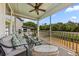 Enjoy outdoor living on this screened porch with comfortable seating and views of the peaceful backyard pond at 1505 Fort Palmetto Cir, Mount Pleasant, SC 29466