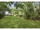 Expansive backyard with mature trees providing shade and privacy at 1522 Inland Ave, Charleston, SC 29412
