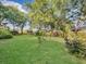 Well-maintained backyard with green grass and scattered trees at 1522 Inland Ave, Charleston, SC 29412