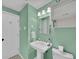 Charming bathroom with modern sink, white fixtures, and a decorative mirror, all illuminated by soft, inviting lighting at 1522 Inland Ave, Charleston, SC 29412