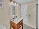 Stylish bathroom featuring a dark wood vanity with a white marble countertop, complemented by modern fixtures and a glass door shower at 1522 Inland Ave, Charleston, SC 29412