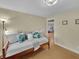 A cozy bedroom featuring a daybed with decorative pillows, wood floors, and inviting natural light at 1522 Inland Ave, Charleston, SC 29412