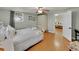 Inviting bedroom with white iron bed frame, complemented by wood floors, a ceiling fan, and a glimpse into a bright adjoining room at 1522 Inland Ave, Charleston, SC 29412