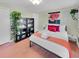 A warm bedroom featuring a comfortable bed, with wood floors, a large plant, and bright artwork for a comfortable retreat at 1522 Inland Ave, Charleston, SC 29412